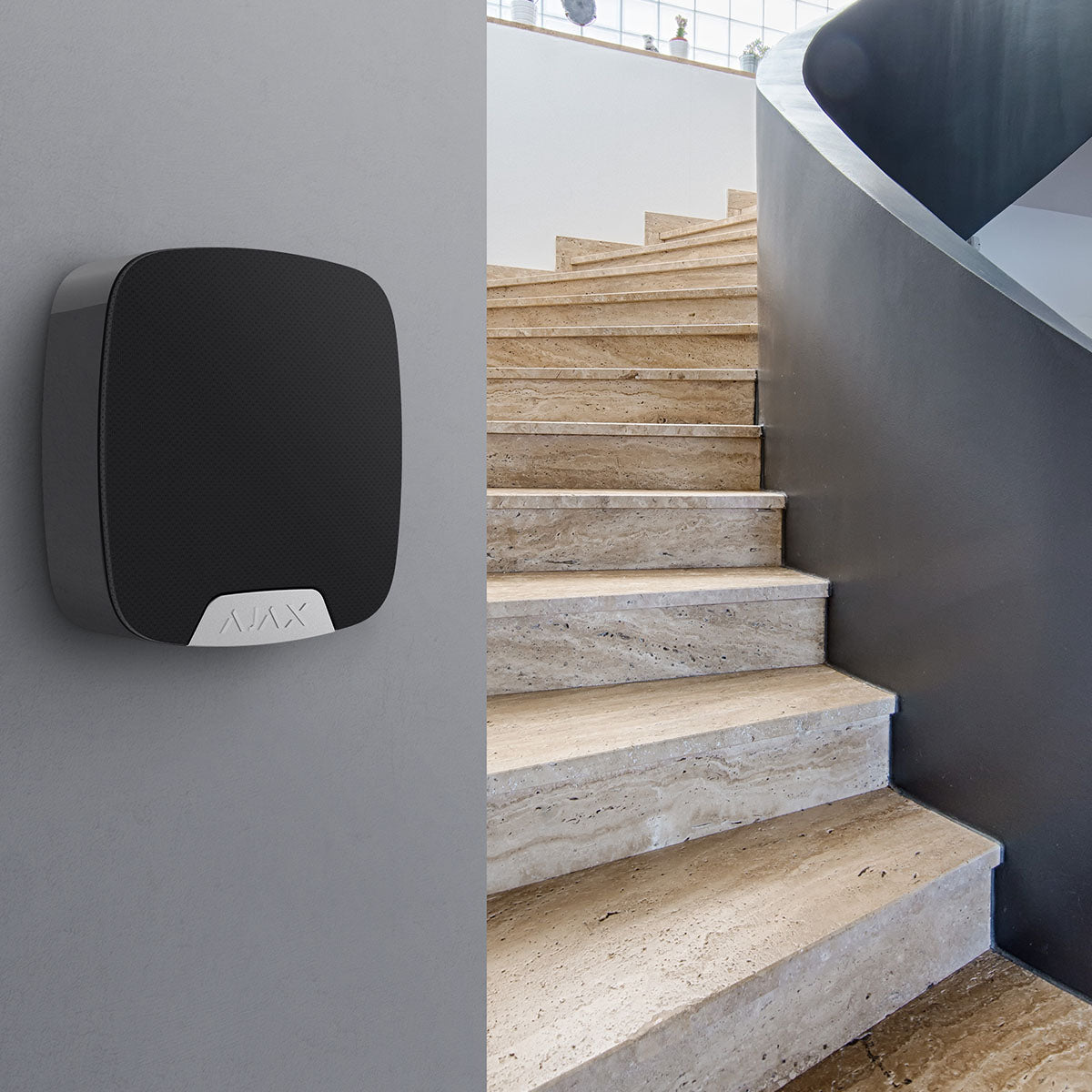 Ajax Compact Wireless Indoor HomeSiren black mounted on wall providing loud alarm for enhanced home security