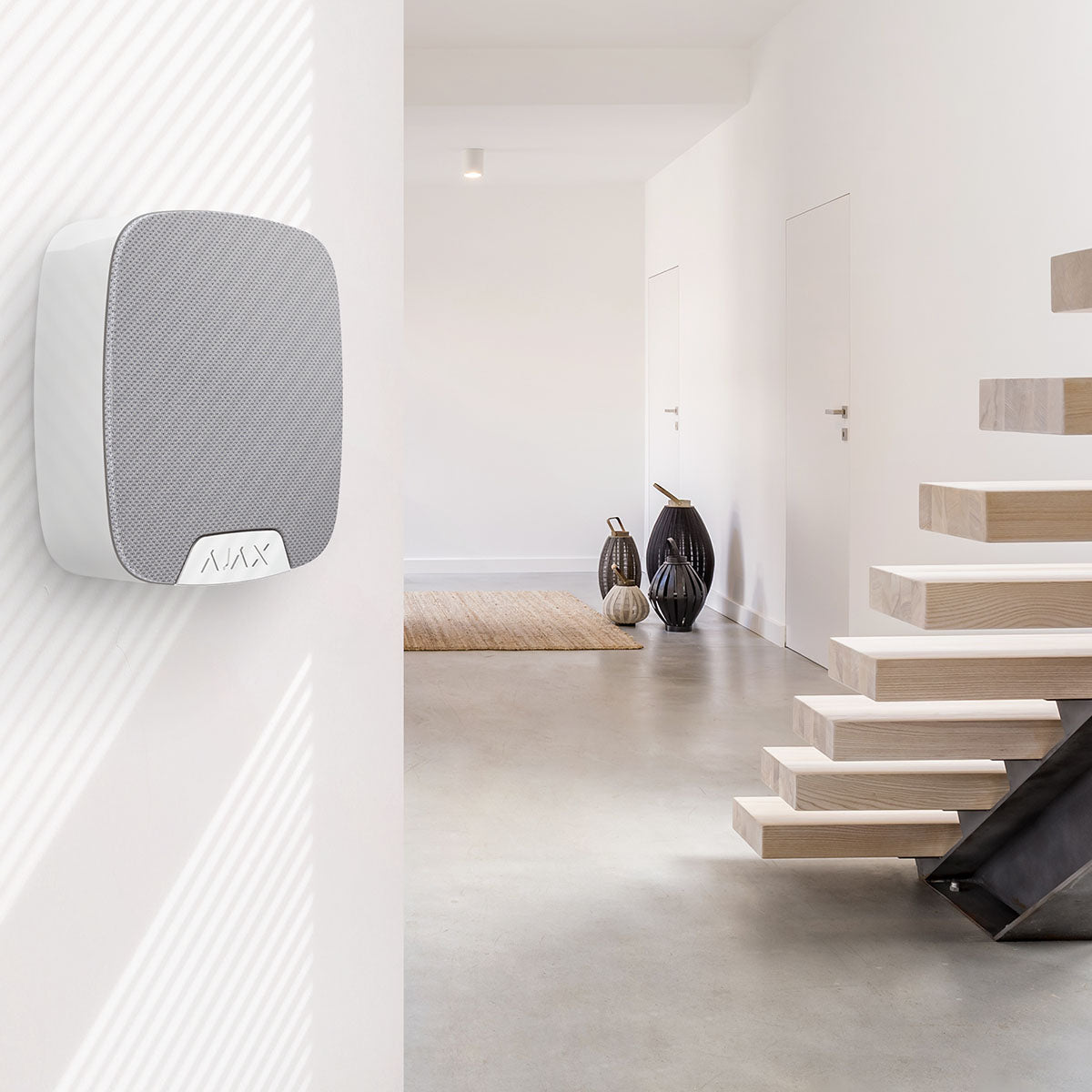 Ajax compact wireless indoor home siren in white.