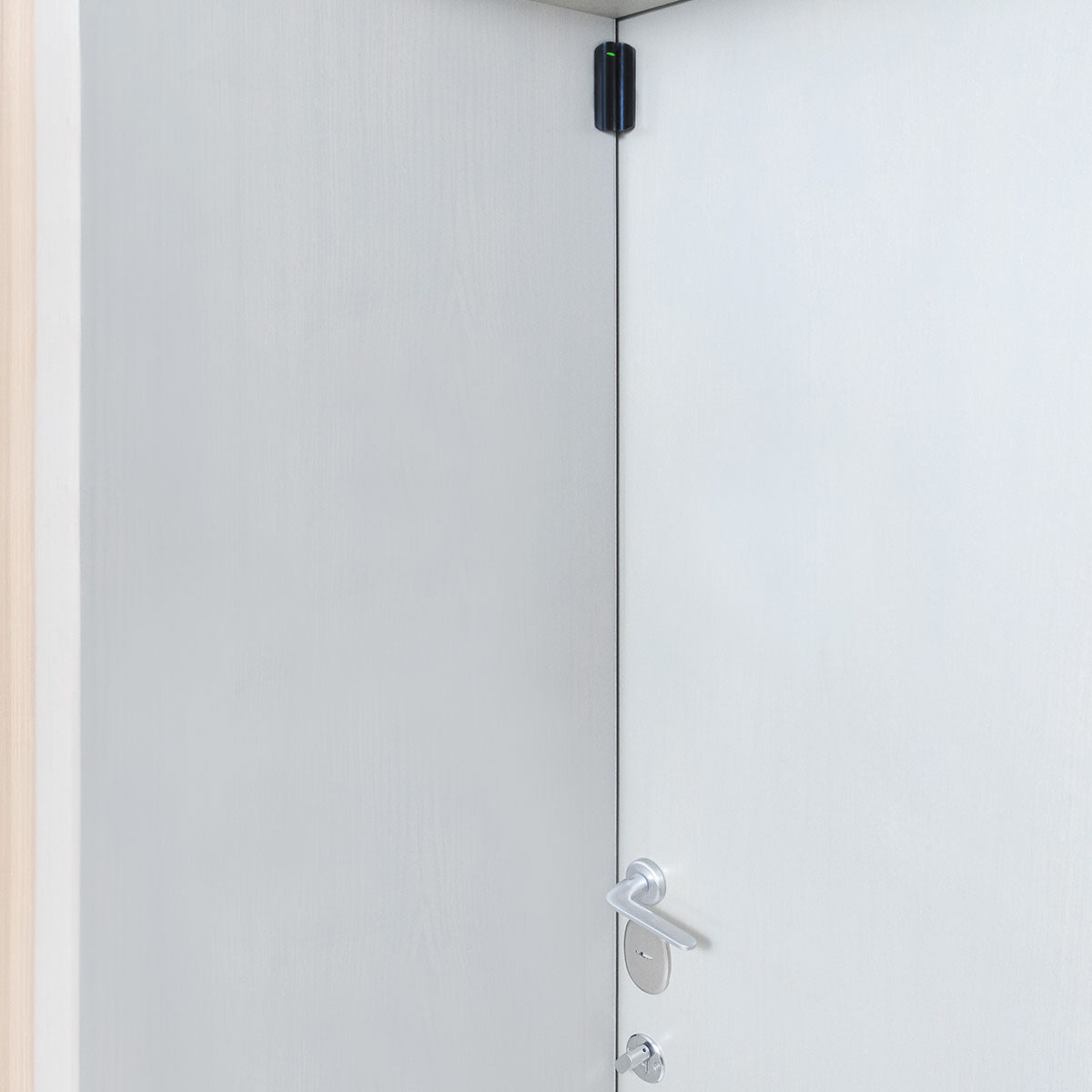 Ajax Wireless DoorProtect black opening detector mounted on frame for advanced home and office intrusion security