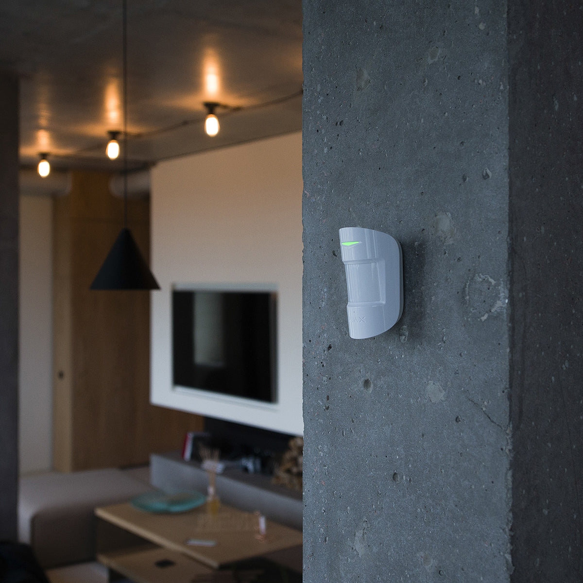 Lifestyle Image of device mounted on a wall with green light indicator.