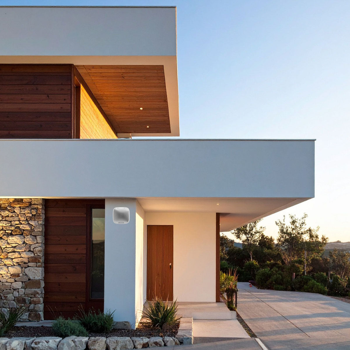 Ajax wireless outdoor 113dB StreetSiren in white, mounted on a home exterior wall for reliable perimeter security.