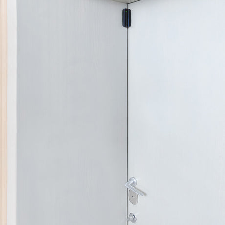 Ajax Wireless DoorProtect black opening detector mounted on frame for advanced home and office intrusion security