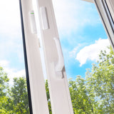 Ajax wireless DoorProtect opening detector in white, installed on a window frame for smart home security and intrusion protection.