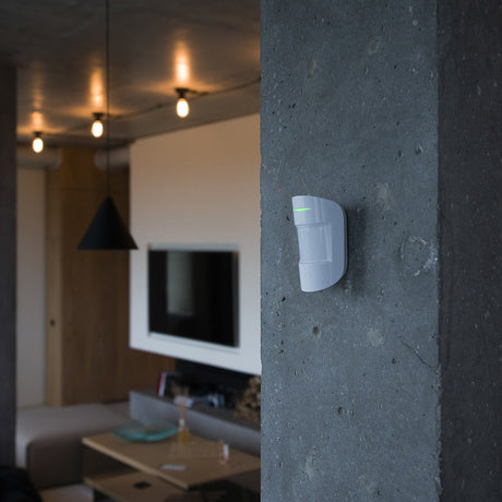Lifestyle Image of device mounted on a wall with green light indicator.